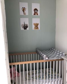 a baby's crib with pictures on the wall