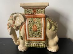 an elephant statue sitting on top of a table