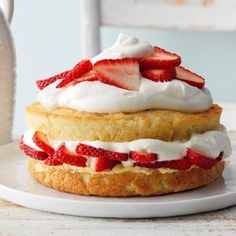 a strawberry shortcake with whipped cream and strawberries