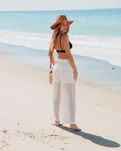 Our White High Waisted Cropped Wide Leg Pants offer a versatile and stylish base for a variety of outfit combinations! The high waist is accentuated by an elastic waistband, ensuring a comfortable fit that flatters the natural waistline. The cropped wide-leg silhouette offers a contemporary look, balancing comfort with a touch of elegance. Pair with a tucked-in graphic tee and sneakers for a laid-back look; or combine with a fitted blouse and blazer for a polished ensemble. High Waist Wide Leg Pants For Beach In Spring, Spring High Waist Wide Leg Pants For Beach, Beachwear Wide-leg Bottoms For Day Out, Wide-leg Beachwear Pants For Day Out, Summer High Waist Wide Leg Pants With Elastic Waistband, Summer High Waist Wide Leg Pants With Elastic Band, Summer High-waist Wide Leg Pants With Elastic Waistband, Summer High Waist Wide Leg Beach Pants, High-waisted Pants For Summer Vacation