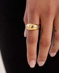 Smooth and futuristic, our 14k gold Dome Ring was created to make a statement while remaining compact enough to stack with other rings alike. Its shiny, polished surface offers a chunky presence and makes a statement solo but looks equally as prodigious when layered with a handful of rings. The Large Dome Ring has been hollowed out for ultra-lightness and measures 10mm at its widest, tapering to 3.5mm in the back for comfortable wear. Made to order. Please allow one week for production. Modern Tarnish-resistant Wide Band Ring, Modern Gold Wide Band Open Ring, Modern Jewelry With Thick Band And Shiny Finish, Modern Gold Jewelry With Thick Band, Modern Wide Band Stackable Rings With Polished Finish, Modern Everyday Dome Ring, Modern Open Ring With Shiny Finish, Everyday Polished Dome Ring, Modern Thick Band Jewelry Tarnish Resistant