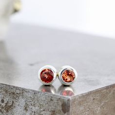 These small sterling silver stud earrings feature sparkly, deep red garnets set in a thick walled sterling bezel. These recycled gemstone studs are the perfect unisex gift and are ready to ship. Garnet is a birthstone for January.These are the perfect every day earrings with just a pop of gorgeous color. These would be perfect in a second piercing, or simply an understated everyday earring for a single piercing.Each gemstone measures 3mm in diameter. The total width of the earrings including the Silver Garnet Birthstone Earrings, Silver Ruby Earrings With Birthstone, Red Sterling Silver Birthstone Earrings, Red Birthstone Sterling Silver Earrings, Sterling Silver Earrings With Bezel Setting As Gift, January Birthstone Jewelry, Red Gemstones, Gemstone Studs, Unisex Gifts