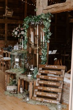 a wooden table topped with lots of candles next to a sign that says you're married