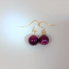 "Just Beautiful Pink Purple Passion Agate Earrings. These Pink Agate Earrings have 12 mm Pink Marble Agate and 14K Gold Filled Wire which is Nickle Free. They dangle beautifully from Handmade and Hammered 14K Gold Filled French Ear Wires. You will receive the exact earrings pictured above. They are handmade and hammered in my Florida Studio. These earrings come with soft silicone earring backs. They are 1 1/2 \" inches long Drop. These earrings have classic lines and are perfect for day wear or Elegant Agate Earrings For Gift, Elegant Agate Earrings As A Gift, Round Agate Ear Wire Jewelry, Round Agate Jewelry With Ear Wire, Agate Earrings With Ear Wire For Gift, Elegant Agate Earrings, Agate Earrings, Pink Agate, Pink Marble