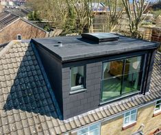 an aerial view of a roof with windows and a skylight on the top floor