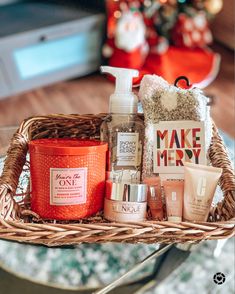 a basket filled with personal care items on top of a table next to a christmas tree