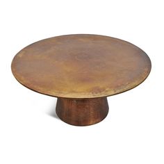 a round metal table with an aged finish on the top and bottom, against a white background