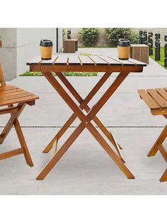 two wooden chairs and a table outside