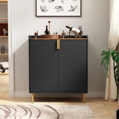 a black cabinet with wine bottles on top in front of a white wall and rug