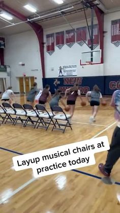 a group of people in a gym with chairs