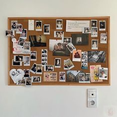 a cork board with pictures and magnets on it