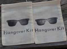 two bags with the words hangover kit hang over each other on a wooden table