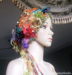 I've created this funky La Belle Epoque retro style VERSATILE TRANSFORMER HEADPIECE - HAT INTO TURBAN.  Cozy, warm, and very feminine PIECE OF WEARABLE FIBER ART with elegance and style.  It is incredibly soft to the touch - the touch of QUALITY.  The headpiece is adorned with TWO HANDCRAFTED LARIATS WITH TASSELS.  It will stretch and is sized for a teen or adult head - 21 to 23 inches.    Care instructions: hand wash the item in lukewarm water.  Squeeze gently. To dry, lay the garment on a flat Bohemian Carnival Headband, Bohemian Headband For Costume, Bohemian Headband For Costume Occasions, Bohemian Multicolor Headwrap For Festival, Multicolor Bohemian Headwrap For Festivals, Adjustable Bohemian Hat For Carnival, Whimsical Adjustable Multicolor Headband, Whimsical Multicolor Adjustable Headpieces, Adjustable Multicolor Festival Headpieces