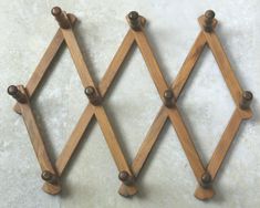 three wooden pegs are hanging on the wall