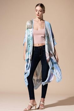 Wrap yourself in elegance with our Watercolor Open Front Kimono! Featuring a delicate and light watercolor effect, this kimono is perfect for everyday wear. The charming stripe border adds a touch of flair to the floral and leaf print, making it suitable for any occasion. One size fits most, making it versatile to layer over jeans, a maxi dress, or even a swimsuit. Crafted from lightweight, flowing fabric, it's the perfect addition to your wardrobe. 100% Viscose Length: 38" Width: 40" One Size F Chic Floral Print Kimono For Spring, Spring Chic Flowy Kimono, Spring Long Patterned Kimono, Flowy Spring Chic Kimono, Blue Printed Kimono For Spring, Feminine Summer Kimono With Kimono Sleeves, Long Patterned Spring Kimono, Casual Wrap Kimono For Spring, Elegant Blue Kimono For Summer