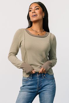 Elevate your wardrobe with our Ashford Striped Top in Olive. With comfortable, stretchy material and cute white strips, this versatile piece is perfect for any occasion. Fitted Long Sleeve Tops With Striped Cuffs, Olive Long Sleeve Top For Layering, Trendy Stretch Olive Tops, Fitted Cotton Tops With Striped Cuffs, Casual Tops With Striped Cuffs, Olive Stretch Tops For Fall, Olive Fitted Long Sleeve Tops, Fitted Olive Long Sleeve Tops, Fitted Top With Striped Sleeves