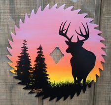 the silhouette of a deer stands in front of an orange and pink sunset