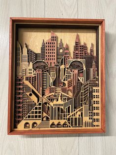 a wooden cut out of a city with skyscrapers