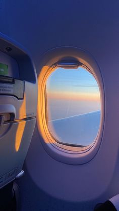 an airplane window looking out at the sky