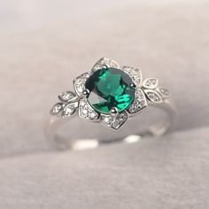 ◆The ring draws inspiration from the polaris. Hand-finished in Sterling sliver, this piece features a round shaped emerald . Clear zirzons decorate around the main stone. An extremely simple celestial ring that you cannot miss. ◆ Production Description: Main stone Type: Emerald Main Stone Shape: Round Main Stone Size:7*7mm(1.30ct) Side stone: CZ Metal: 925 Sterling silver - Other options available in the drop down menu ◆ Customization: √Free for Add Engraving √Other Metal Type Available √Other G Emerald Ring With Halo Design For May Birthstone, Round Emerald Ring With Halo Design For May Birthstone, Silver Emerald Jewelry With Halo Design, Silver Diamond Ring With Emerald And Halo Design, Silver Emerald Diamond Ring With Halo Design, Emerald Ring With Center Stone, Elegant Emerald Ring With Round Stone, Elegant Round Emerald Ring, Fine Jewelry Emerald Birthstone Ring