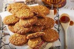 cookies are stacked on top of each other in front of a jar of ketchup