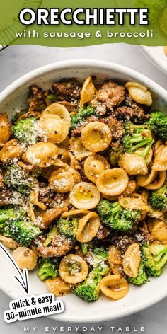 a bowl filled with pasta and broccoli on top of a table