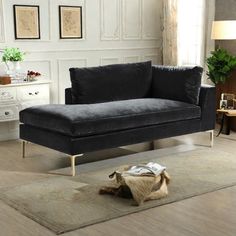 a black couch sitting on top of a rug in a living room