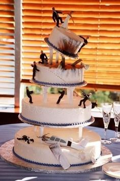 a three tiered wedding cake with figurines on top