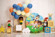 a birthday party with balloons, toys and decorations