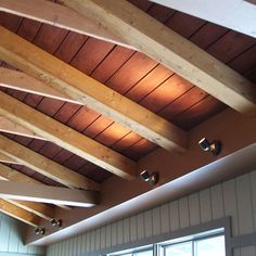 the inside of a building with wooden beams