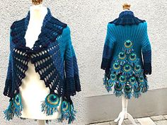 two mannequins dressed in blue and green crocheted clothing with peacock feathers on them