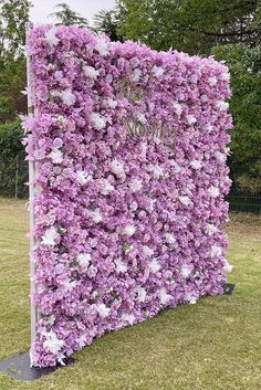 a large purple and white flower covered wall