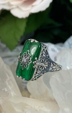 Emerald Green Glass & CZ Intricate Filigree Ring (Inset Gem: CZ, Moissanite, or Diamond) Intricate Filigree Ring Grace Design#233 Custom Made I now offer this lovely Antique Art Deco/Edwardian design ring in sterling silver. This gorgeous ring is set with a stunning floral filigree embellished emerald green glass/resin with a centered inset 1mm white round full cut CZ, Moissanite, or Natural Diamond. The glass is 18mm Long by 19mm Wide. The ring sits 19mm North South on the finger and 10mm East Edwardian Design, Emerald Green Stone, Floral Filigree, Gem Diamonds, Gorgeous Ring, Glass Ring, Emerald Color, North South, Filigree Design