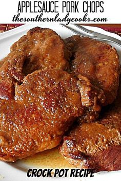 two pieces of meat sitting on top of a white plate