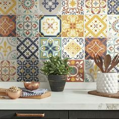 a kitchen counter topped with lots of colorful tiles