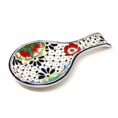 a decorative ceramic spoon with flowers on it