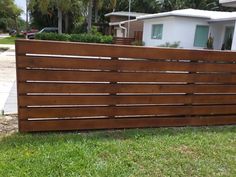 a wooden fence in front of a house