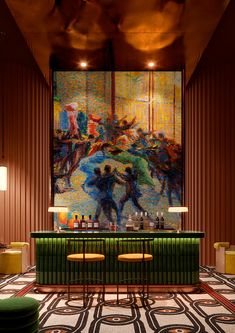 a bar with stools in front of a large painting