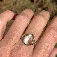 Andesine is named for the Andes mountains where it was first discovered in 1841. It gets its beautiful shades of reds and oranges from the trace amounts of copper contained in the stone. This blush Andesine is perfectly accented with a pair of sparkling orange sunstones, a truly spectacular ring finished with a hand carved sterling silver seagrass band. Approximate stone size: 15mm x 12mm Approx ct weight: 4.45cts This one of a kind piece is handmade to in Emily's Hudson Valley studio. This piec Stacked Engagement Ring, Beads Ring, Birthstone Stacking Rings, Andes Mountains, Imperial Topaz, Diamond Shop, London Blue Topaz, Beaded Rings, Hudson Valley