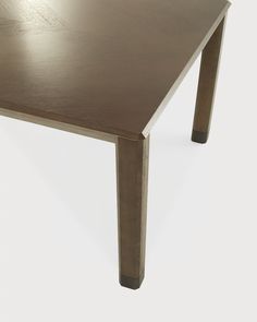 a wooden table sitting on top of a white floor