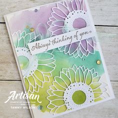 a close up of a greeting card with flowers on the front and bottom, which says always thinking of you