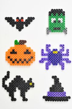 four perler beads are arranged in the shape of pumpkins, bats and witches