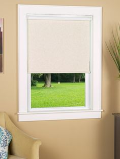 a living room with an open window and green grass