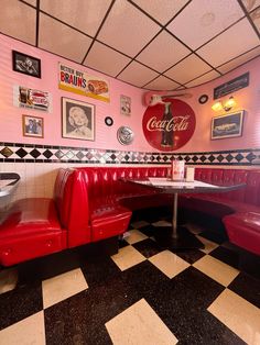 a diner booth with red booths and black and white checkered flooring on the walls