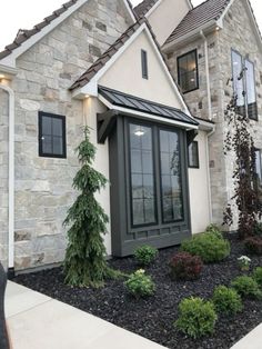 a house that has some plants in front of it