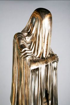 a golden statue sitting on top of a wooden table