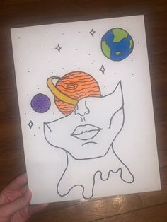 a person holding up a piece of paper with an image of the earth on it