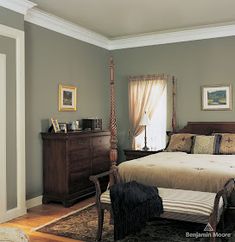 a bed sitting in a bedroom next to a dresser