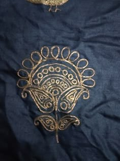 two pieces of cloth with gold embroidery on them