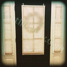 two open windows with blinds on them in front of a black wall and the bottom one is closed